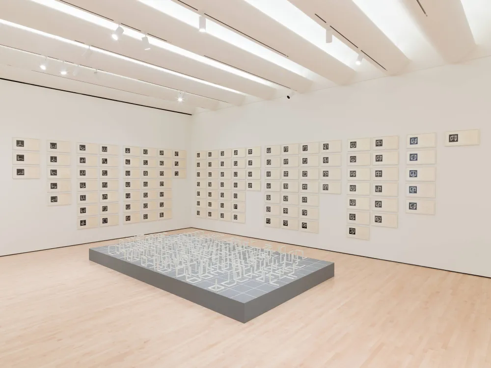 Sol LeWitt’s Incomplete Open Cubes installed as 122 white structures with drawings and photographs